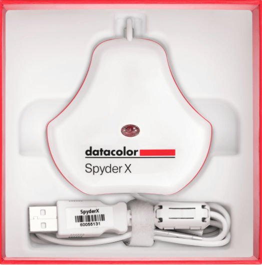 Spyder X hardware shown as it appears when you open the box, including USB cable